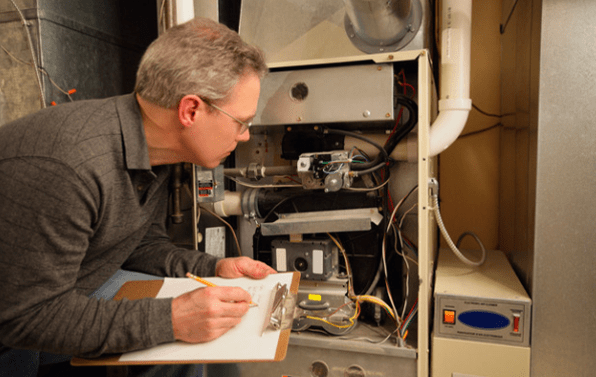 a technician is inspecting a furnace